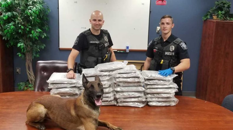 Apex, the dog, and Marietta cops arrested two people on drug charges after they say they found all that marijuana in a storage unit.