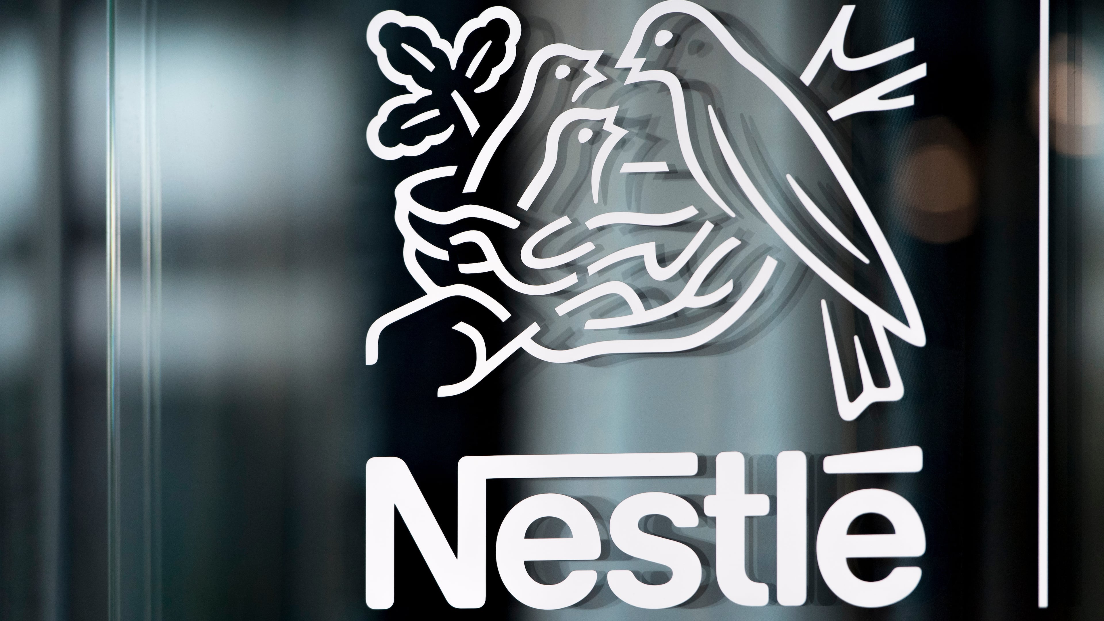 FILE - In this Thursday, Feb. 14, 2019, file photo, Nestle's logo is displayed on a window, during the 2018 full-year results press conference of the food and drinks giant Nestle, in Vevey. (Laurent Gillieron/Keystone via AP, File)