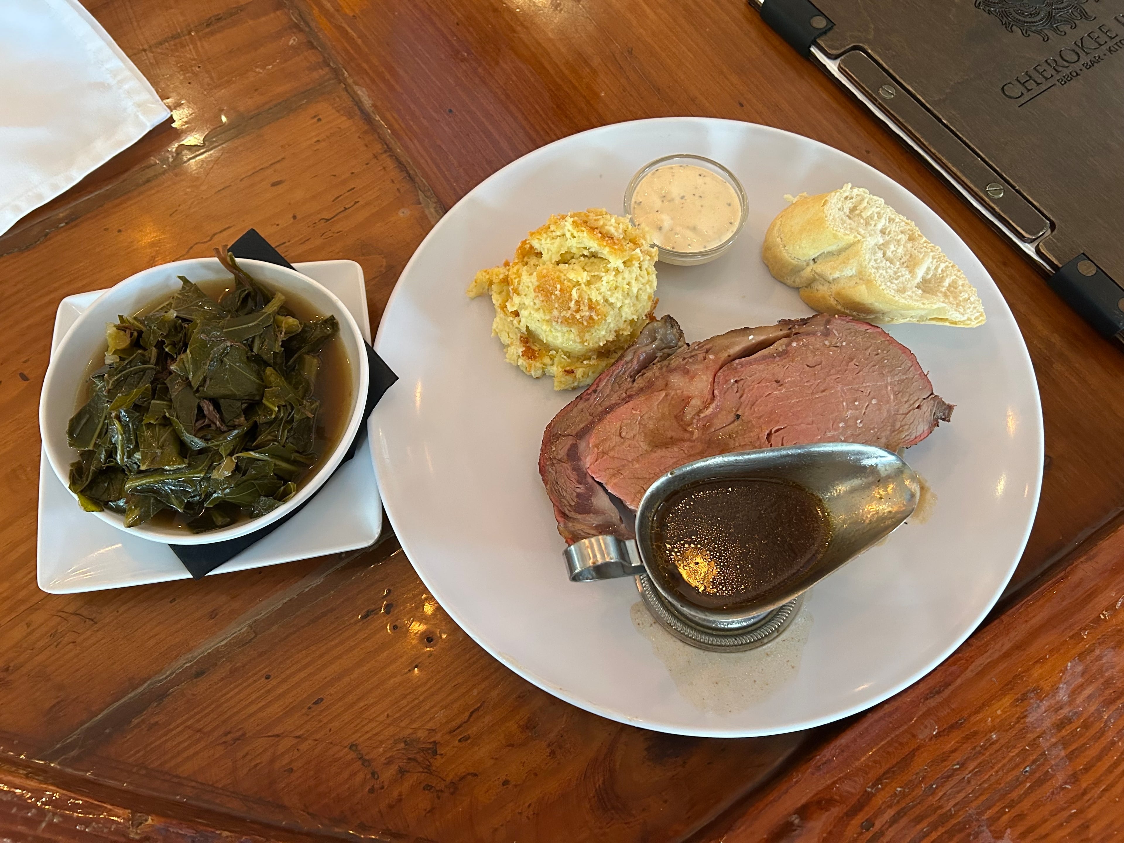 At Cherokee Rose in Stone Mountain, a dinner of smoked prime rib, jalapeno corn pudding, and collard greens. RFK Jr. had the same meal on his visit to the restaurant, with a larger piece of prime rib. (Thomas Lake/AJC)