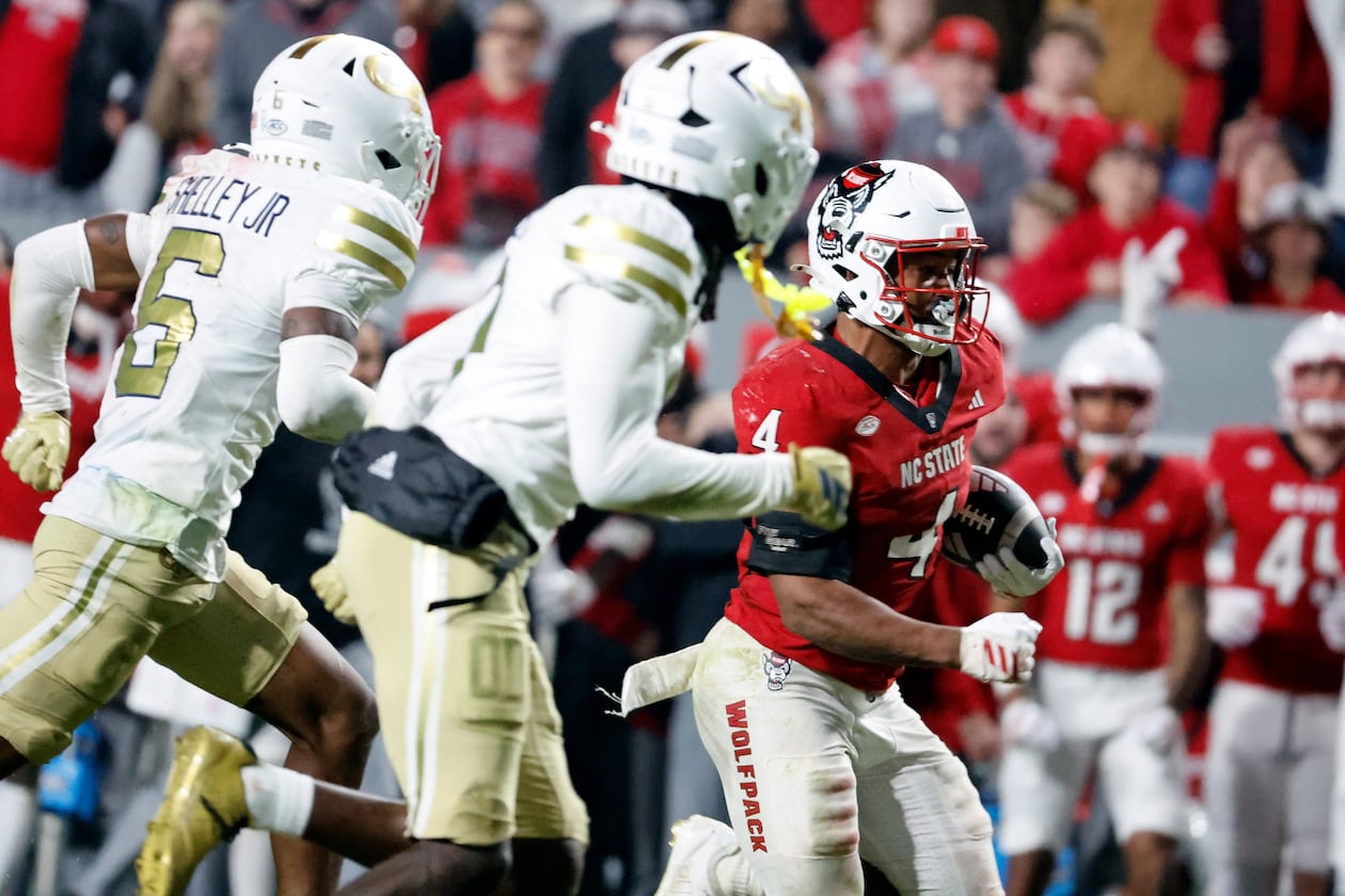 North Carolina State running back Jayden Scott (right), a Stockbridge High graduate, runs past Georgia Tech defenders during the second half Saturday, Nov. 1, 2025, in Raleigh, N.C. Scott ran for a career-high 196 yards and a touchdown. (Karl DeBlaker/AP)