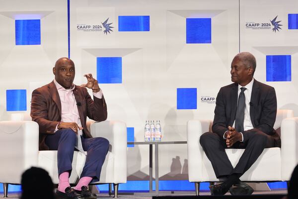 George Nichols (left), president and CEO of the American College of Financial Services, speaks to Raphael Bostic, president of the Atlanta Federal Reserve, during the Conference of African American Financial Professionals in Atlanta in August 2024. (Natrice Miller/AJC 2024)