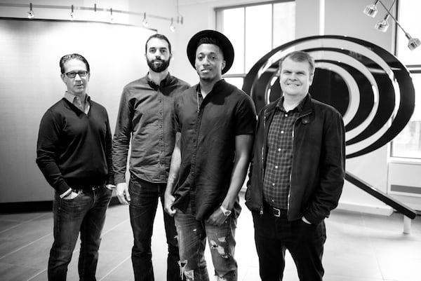 Left to right: Joel Klaiman, executive vice president and general manager of Columbia Records; Ben Washer, co­‐owner/CEO of Reach Records; Lecrae; and Rob Stringer, chairman and CEO of Columbia Records.
