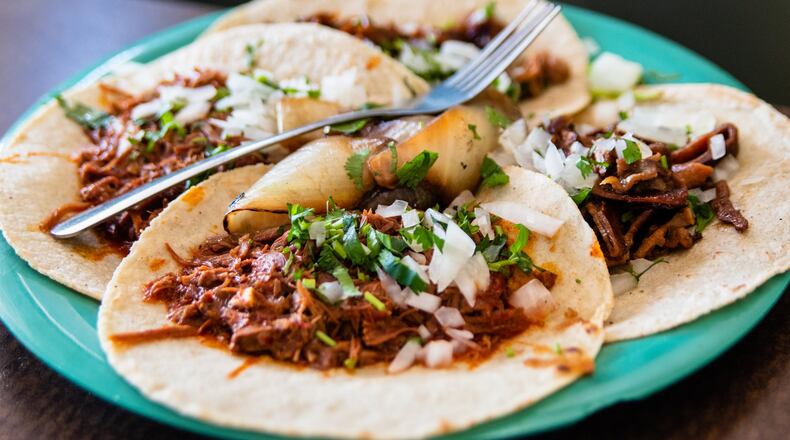A plate of four tacos from El Rey Del Taco, including goat barbacoa (foreground) and buche, or pig stomach (background). CONTRIBUTED BY HENRI HOLLIS