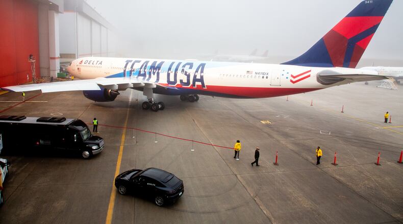 Delta employees prepare the area around Delta's new Team USA plane. Delta will be an Olympic sponsor and Team USA's official airline.  STEVE SCHAEFER FOR THE ATLANTA JOURNAL-CONSTITUTION