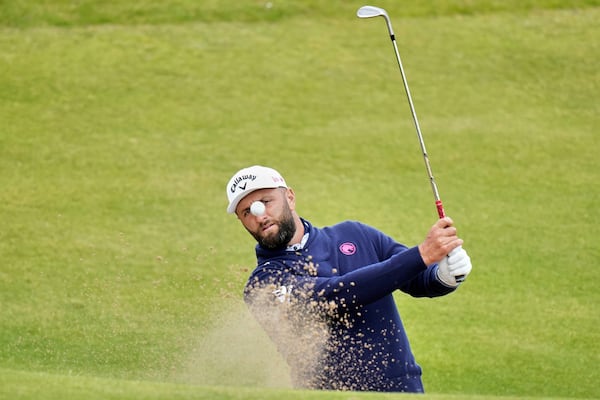 Jon Rahm of Spain plays out of a bunker on the 7th green during a practice round for the British Open golf championship at the Royal Portrush Golf Club, Northern Ireland, Tuesday, July 15, 2025. (AP Photo/Francisco Seco)