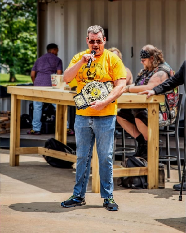 Nick Patrick is the co-founder of Deep South Wrestling and the son of professional wrestler Jody Hamilton, the masked "Assassin" (featured on the pictured championship belt). (Courtesy of Deep South Wrestling)