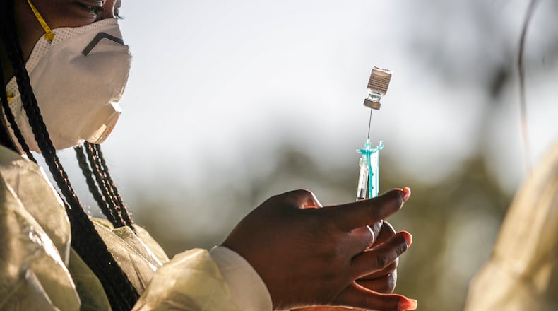 Leshea Moore, from Michigan, prepares a Pfizer-BioNTech COVID-19 vaccine at the Ontario Convention Center. This was the 35-year-old’s first stint as a travel nurse. (Irfan Khan/Los Angeles Times/TNS)