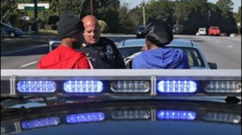 Officer Phillip Perry, shift senior officer and training officer for the Jonesboro police department, stops a motorist for having no insurance, a violation flagged by the tag reader. Perry goes on traffic patrol with the department’s license plate reader equipped patrol car. BOB ANDRES / BANDRES@AJC.COM