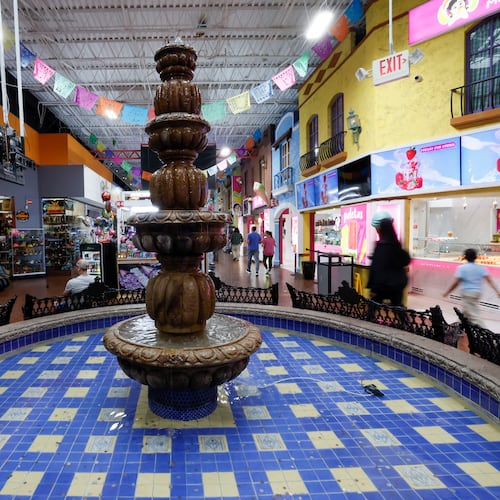 People walk up and down the main aisle at Plaza Fiesta on Wednesday, May 7, 2025. Some shop owners have observed a decline in their sales. The Trump administration has caused immigrant communities to feel worried and uncertain. (Miguel Martinez/AJC)