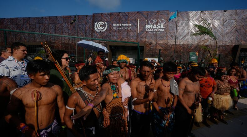 An Indigenous group blocks an entrance to the COP30 U.N. Climate Summit, Friday, Nov. 14, 2025, in Belem, Brazil. (AP Photo/Fernando Llano)