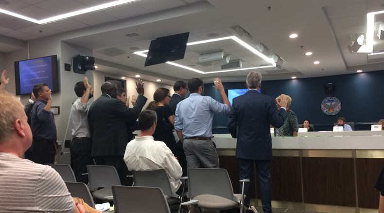 Developers, residents and city officals are sworn in at an Atlanta Tree Conservation Commission appeal hearing.