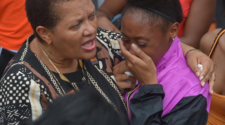 Savannah State University President Cheryl Dozier, left, comforts a student following a noon vigil for slain student Christopher Starks on Friday, Aug. 28, 2015 in Savannah, Ga. Starks, 22, died at a hospital of gunshot wounds sustained during an altercation at the student union on Thursday night. (Steve Bisson/Savannah Morning News via AP)