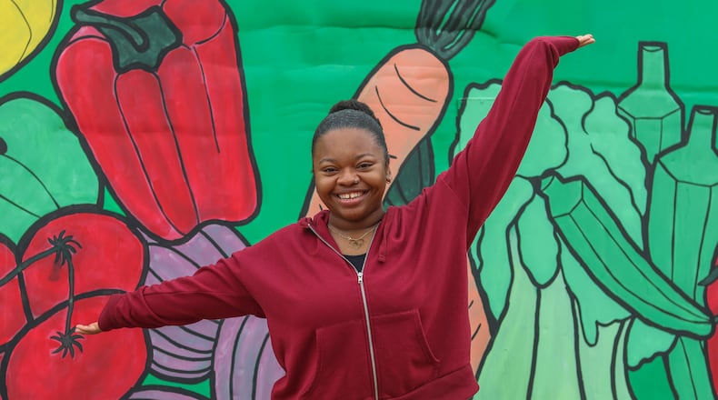 Aliyah Williams, 22, a Black fifth-year student at the University of Georgia from Lawrenceville., Georgia completes a food delivery with Campus Kitchen and UGArgen which she was inspired to join in part due to her personal encounters with food insecurity growing up with three siblings. Williams poses for a portrait at UGArden in Athens, Georgia on Friday, Nov. 10, 2023. (Photo Courtesy of Samantha Hurley)