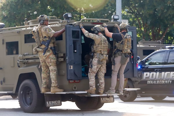 Police officers ride in a vehicle down Houston Mill Rd after an active shooter was seen near the Emory and CDC campus, Friday, August 8, 2025, in Atlanta. (Jenni Girtman for The Atlanta Journal-Constitution)