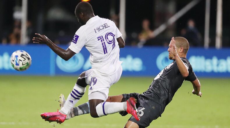 Orlando City's Benji Michel (19) leaps in front of Minnesota United's Osvaldo Alonso during the MLS is Back tournament at Disney's ESPN Wide World of Sports in Orlando, Florida, on Thursday, Aug. 6, 2020. Orlando City won, 3-1. (Stephen M. Dowell/Orlando Sentinel/TNS)