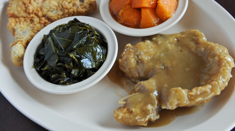 Fried and smothered pork chops with yams and collards at Busy Bee Cafe.(BECKY STEIN)
