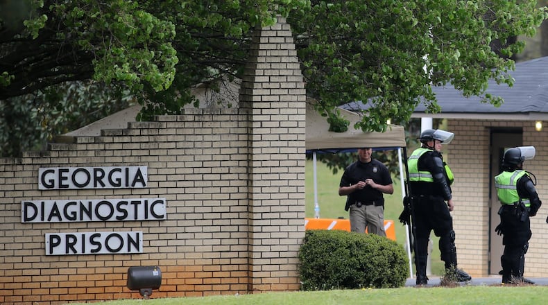 Corrections officers guard the entrance to the Georgia Diagnostic and Classification State Prison in advance of the execution of Joshua Bishop on Thursday evening, March 31, 2016. (Ben Gray / bgray@ajc.com)