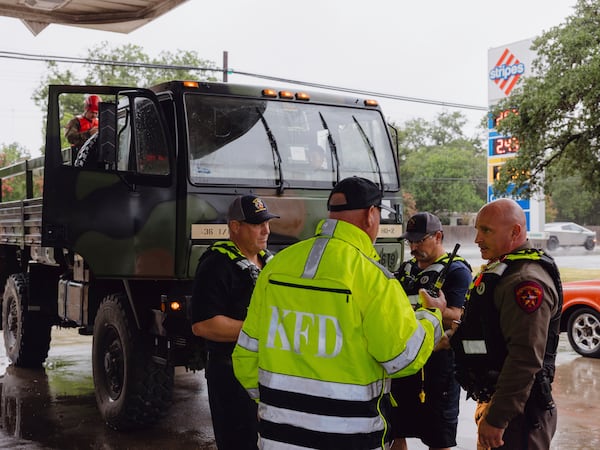 Members the Kerrville Fire Department and Texas Department of Public Safety refuel trucks after deadly flooding in Kerrville, Texas, Friday July 4, 2025. (Christopher Lee/The San Antonio Express-News via AP)