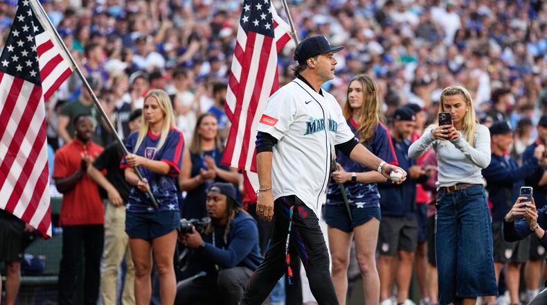 FILE - United States men's national soccer team head coach Mauricio Pochettino walks out to throw out the ceremonial first pitch before a baseball game between the Seattle Mariners and the Toronto Blue Jays, July 3, 2026, in Seattle. (AP Photo/Lindsey Wasson, File)