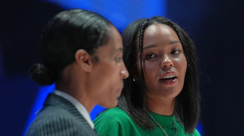 Lunar Owls forward Napheesa Collier, right, talks with guard Skylar Diggins as both sit out with injuries at the start of their Unrivaled 3-on-3 basketball game against Rose BC, Monday, Jan. 5, 2026, in Medley, Fla. (AP Photo/Rebecca Blackwell)