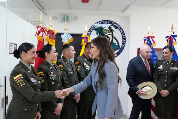 Homeland Security Secretary Kristi Noem greets officers as she arrives for a meeting with the National Police's Counter Organized Crime Group at the Colombian National Police Directorate in Bogota, Columbia, Thursday, March 27, 2025. (AP Photo/Alex Brandon)