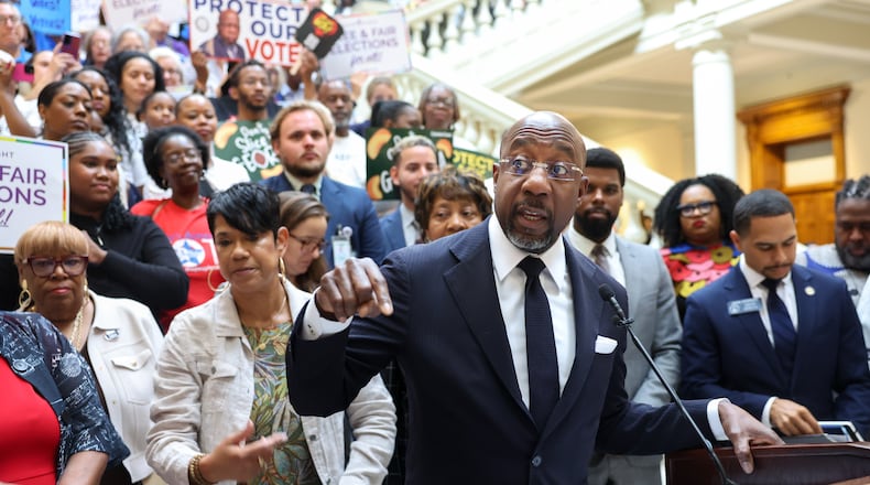Democratic U.S. Sen. Raphael Warnock speaks at a news conference before the state Legislature convenes for a special session in Atlanta last month. (Arvin Temkar/AJC)