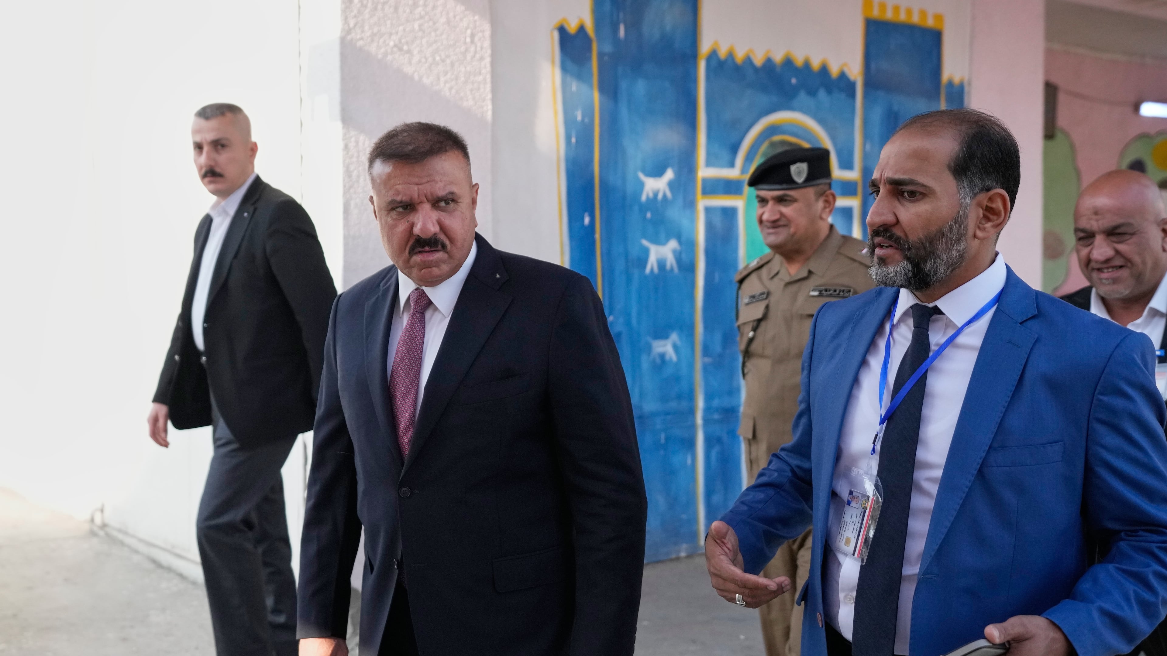 Iraq's Interior Minister Abdul Amir al-Shammari, center, visits one of the polling centers during a special voting session ahead of Tuesday's parliamentary election in Baghdad, Iraq, Sunday, Nov. 9, 2025. (AP Photo/Hadi Mizban)