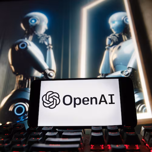 FILE - The OpenAI logo is displayed on a cellphone with an image on a computer monitor generated by ChatGPT's Dall-E text-to-image model, Dec. 8, 2023, in Boston. (AP Photo/Michael Dwyer, File)