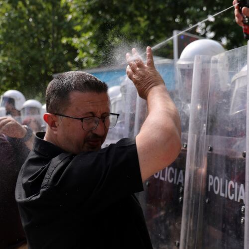 A riot police officer uses pepper spray against a protester during clashes at an anti-government rally in Tirana, Albania, Thursday, July 2, 2026. (AP Photo/Hameraldi Agolli)