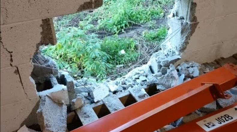 A hole was punched through a cinderblock wall at the Empty Stocking Fund warehouse.