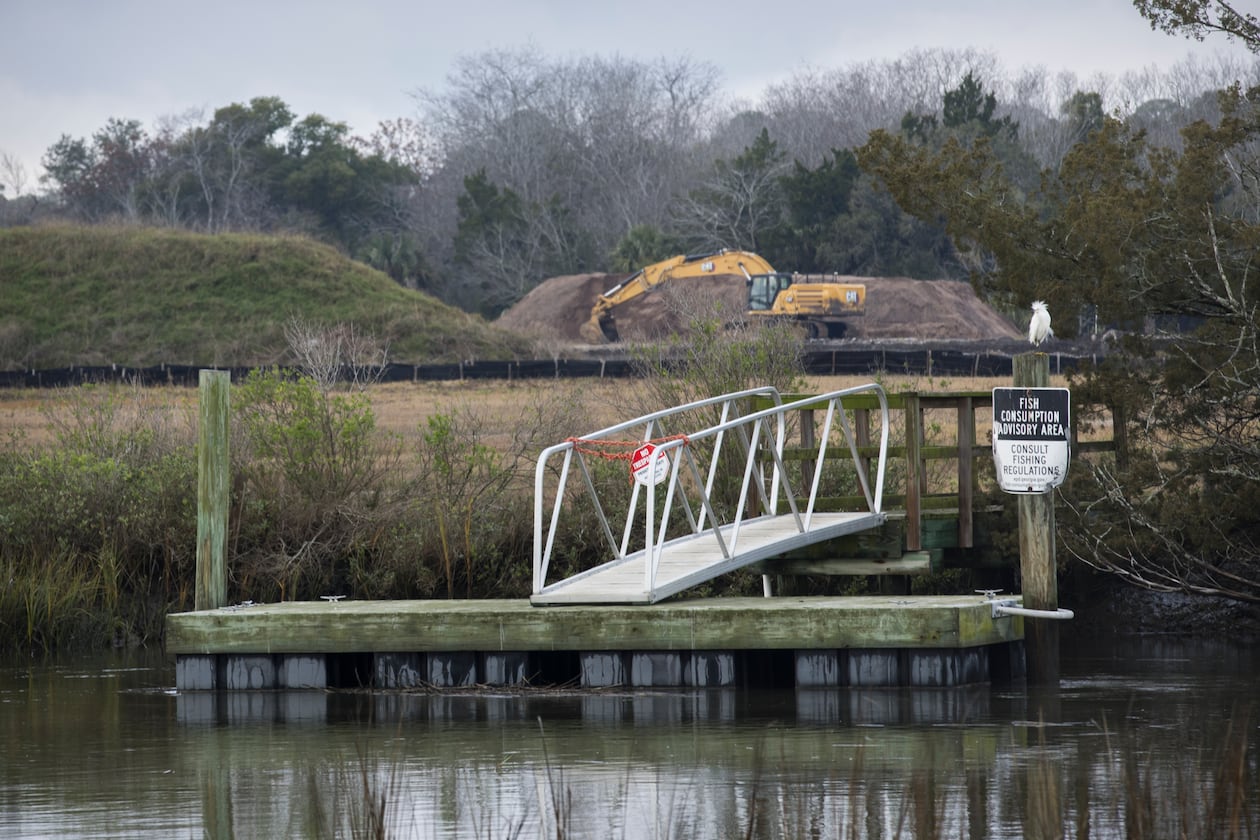 A dock with a fish consumption advisory sign is shown near the Terry Creek Dredge Spoil Areas/Hercules Outfall Superfund site in Brunswick. The site is one of four Superfund sites located around Brunswick, and active clean-up work is ongoing. (AJC Photo/Stephen B. Morton)