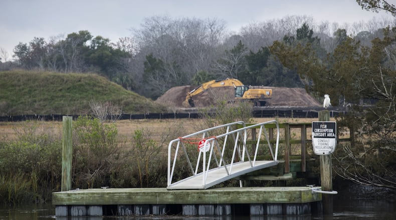 A dock with a fish consumption advisory sign is shown near the Terry Creek Dredge Spoil Areas/Hercules Outfall Superfund site in Brunswick. The site is one of four Superfund sites located around Brunswick, and active clean-up work is ongoing. (AJC Photo/Stephen B. Morton)