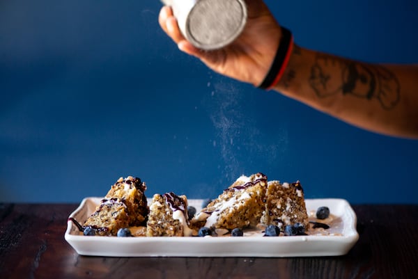 The Lost Druid dessert special cake with blueberries and topped with powdered sugar.