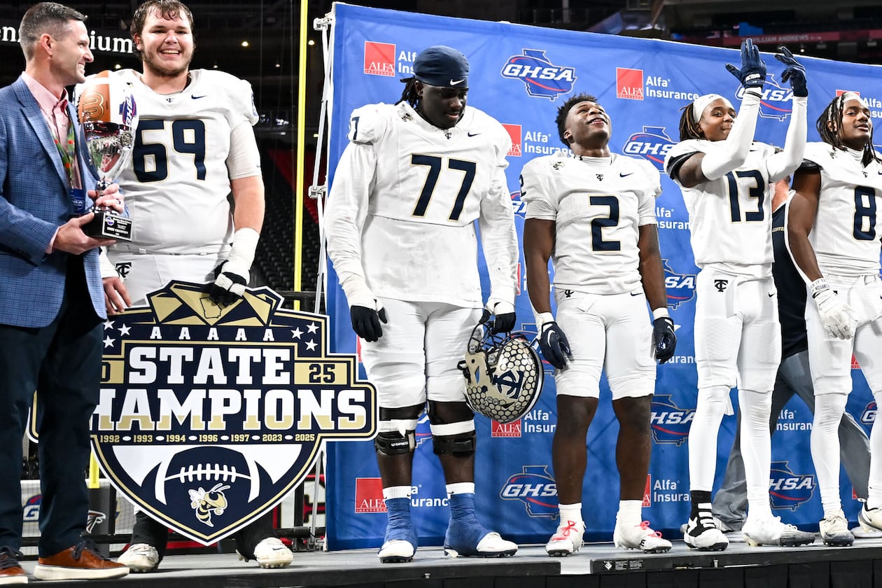 Deontavis Cooper (77), center, is shown with his teammates after the Thomas County Central Yellow Jackets beat the Gainesville Red Elephants 62-21 to win their Class 5A championship game Wednesday, Dec. 17, 2025, at Mercedes-Benz Stadium. (Daniel Varnado for the AJC)