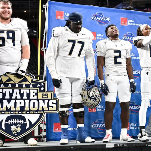 Deontavis Cooper (77), center, is shown with his teammates after the Thomas County Central Yellow Jackets beat the Gainesville Red Elephants 62-21 to win their Class 5A championship game Wednesday, Dec. 17, 2025, at Mercedes-Benz Stadium. (Daniel Varnado for the AJC)