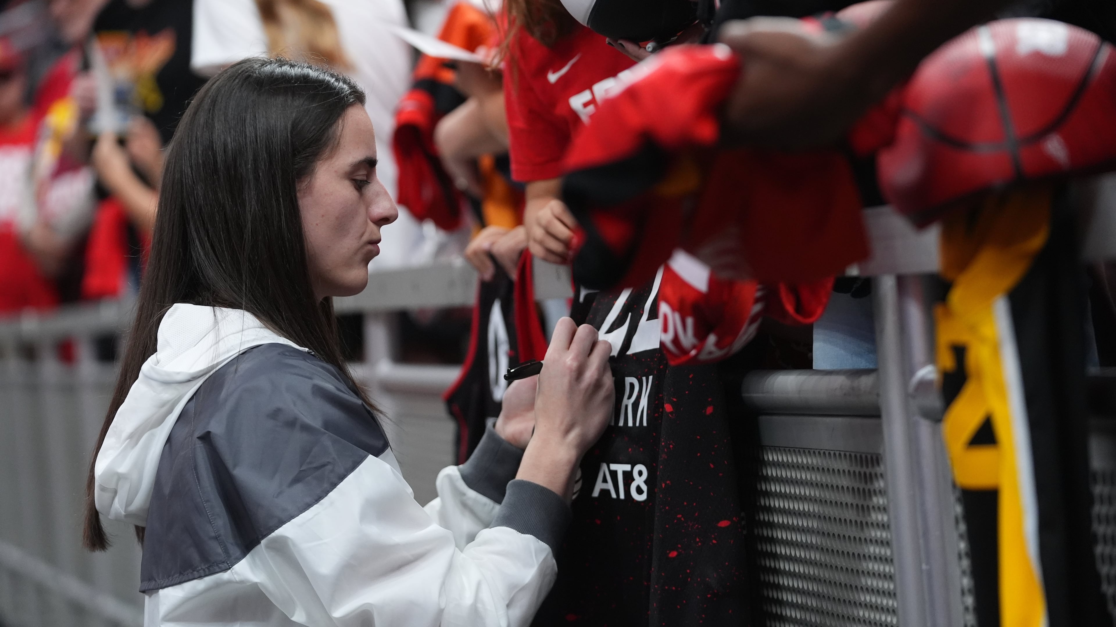 Indiana Fever's Caitlin Clark signs autographs before Game 3 of a WNBA basketball playoff semifinals series against the Las Vegas Aces, Friday, Sept. 26, 2025, in Indianapolis. (AP Photo/Darron Cummings)