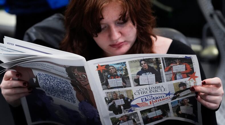 FILE - Columbia College Chicago student Kailey Ryan reads a newspaper in Chicago, Nov. 5, 2024. (AP Photo/Nam Y. Huh, File)