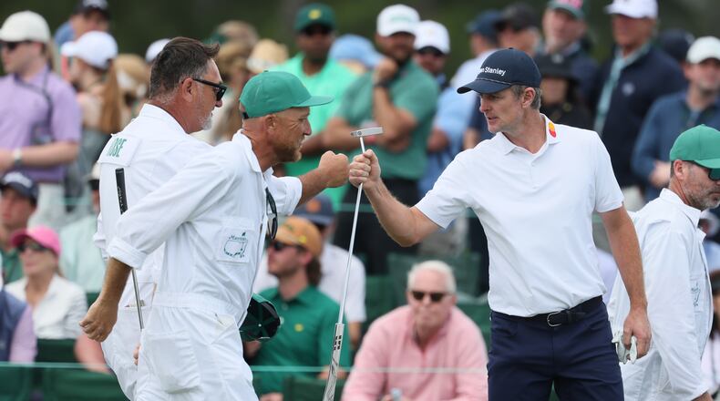 Justin Rose fist bumps caddie Mark Fulcher during second round of the Masters golf tournament, at Augusta National Golf Club, Friday, April 11, 2025, in Augusta, Ga. (Jason Getz / AJC)