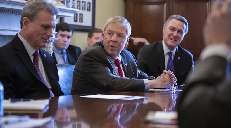 Sen. Johnny Isakson, R-Ga., (center) was released from a hospital in Washington, D.C., Saturday after falling and breaking four ribs this week. He is expected to begin physical therapy at a hospital in Marietta. AP Photo/J. Scott Applewhite