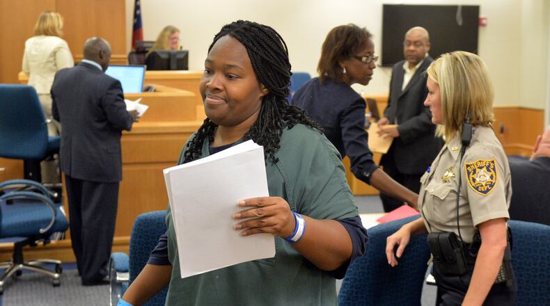 Therian Wimbush, seen here in an August 2014 file photo, has filed a civil lawsuit alleging that several judges, attorneys, child services workers and other officials slandered her family. KENT D. JOHNSON/KDJOHNSON@AJC.COM