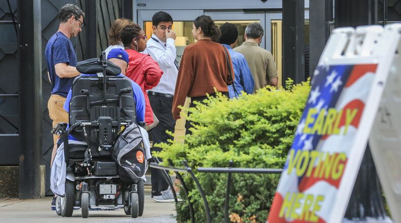 Early voters lined up before the doors opened Oct. 15, 2018, at the Buckhead Library in Atlanta. JOHN SPINK/JSPINK@AJC.COM