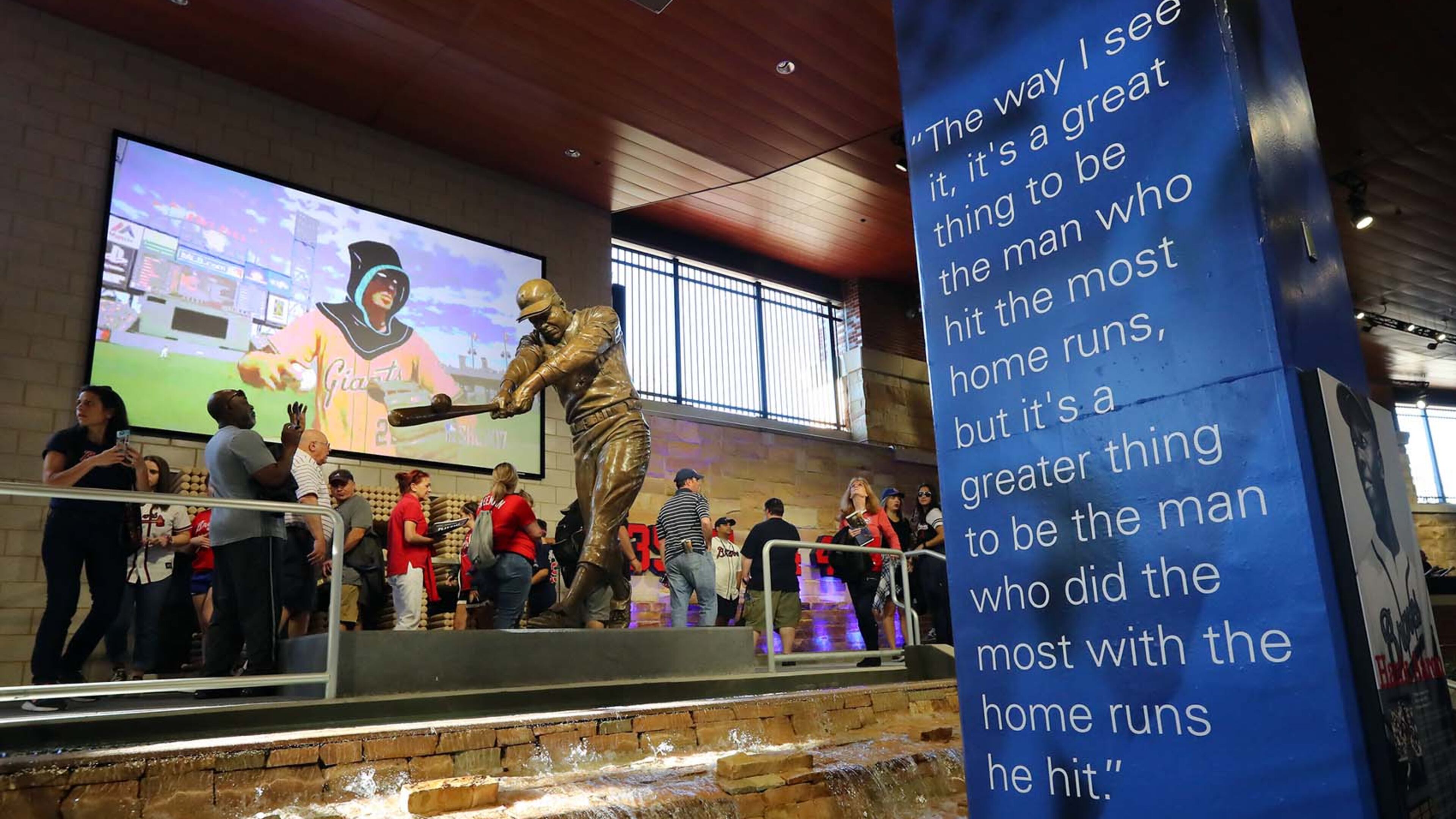 March 31, 2017, Atlanta: Braves fans take in the Hank Aaron statue in Monument Garden during the MLB exhibition game against the N.Y. Yankees for the soft opening of SunTrust Park on Friday, March 31, 2017, in Atlanta. Curtis Compton/ccompton@ajc.com