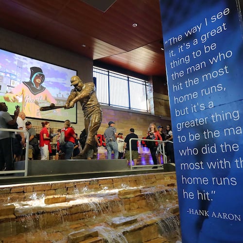 March 31, 2017, Atlanta: Braves fans take in the Hank Aaron statue in Monument Garden during the MLB exhibition game against the N.Y. Yankees for the soft opening of SunTrust Park on Friday, March 31, 2017, in Atlanta. Curtis Compton/ccompton@ajc.com