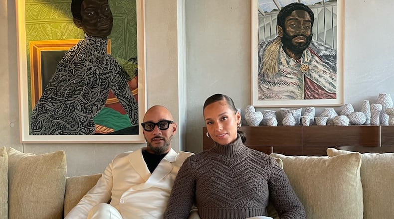 Alicia Keys and Swizz Beatz in their La Jolla, California, home with paintings by Toyin Ojih Odutola, "Paris Apartment" (left) and "The Envoy."