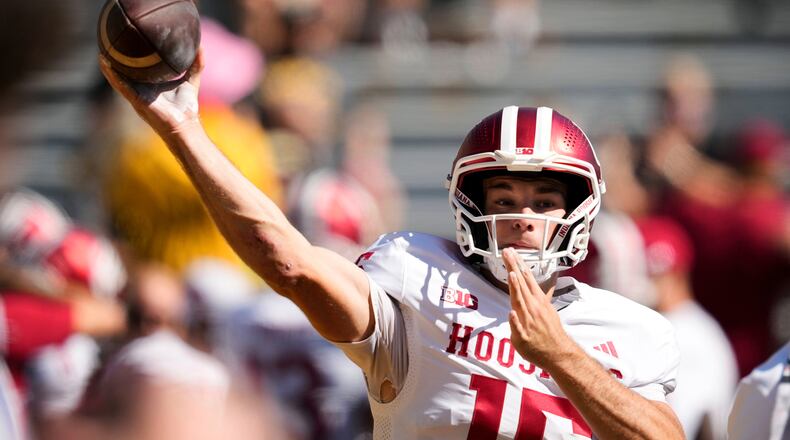 FILE - Indiana quarterback Fernando Mendoza warms up before an NCAA college football game against Iowa, Saturday, Sept. 27, 2025, in Iowa City, Iowa. (AP Photo/Charlie Neibergall, File)