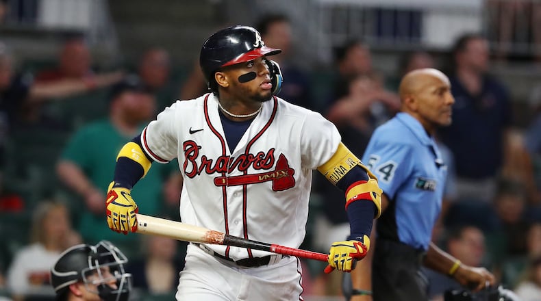 Braves designated hitter Ronald Acuna watches his home run leave the park against the Rockies on Wednesday night at Truist Park. (Curtis Compton / Curtis Compton@ajc.com)