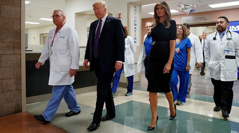 President Donald Trump and first lady Melania Trump walk with surgeon Dr. John Fildes, meeting with survivors of the mass shooting Wednesday, Oct. 4, 2017, in Las Vegas. (AP Photo/Evan Vucci)