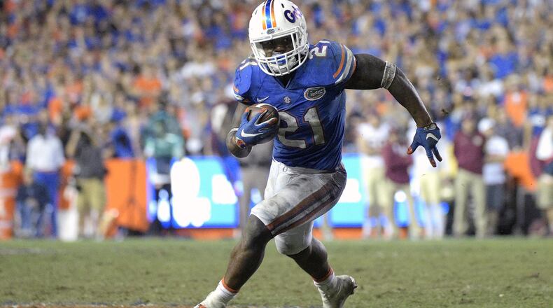 Florida running back Kelvin Taylor (21) rushes for yardage during the second half of an NCAA college football game against Florida State in Gainesville, Fla. Taylor signed with the Atlanta Falcons on Tuesday, Aug. 8, 2017. (AP Photo/Phelan M. Ebenhack, File)
