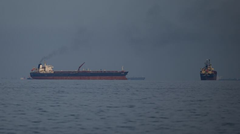 Oil tankers and cargo ships line up in the Strait of Hormuz as seen from Khor Fakkan, United Arab Emirates, Wednesday, March 11, 2026. (AP Photo/Altaf Qadri)
