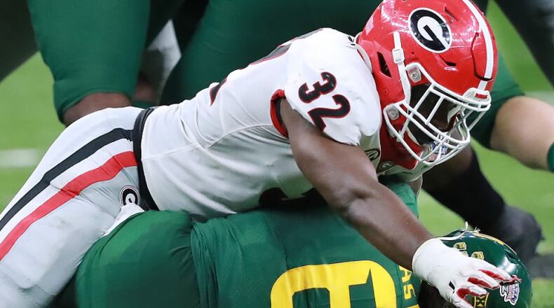 Georgia inside linebacker Monty Rice, here tackling Baylor running back JaMycal Hasty in the Sugar Bowl in January, has expressed frustration at the contradictory feedback football players are getting from college athletics leadership. (Curtis Compton/ccompton@ajc.com)